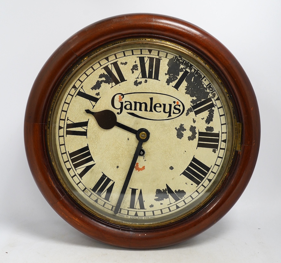 An early 20th century mahogany single fusee Gamleys advertising dial clock, 39cm diameter. Condition - poor to fair